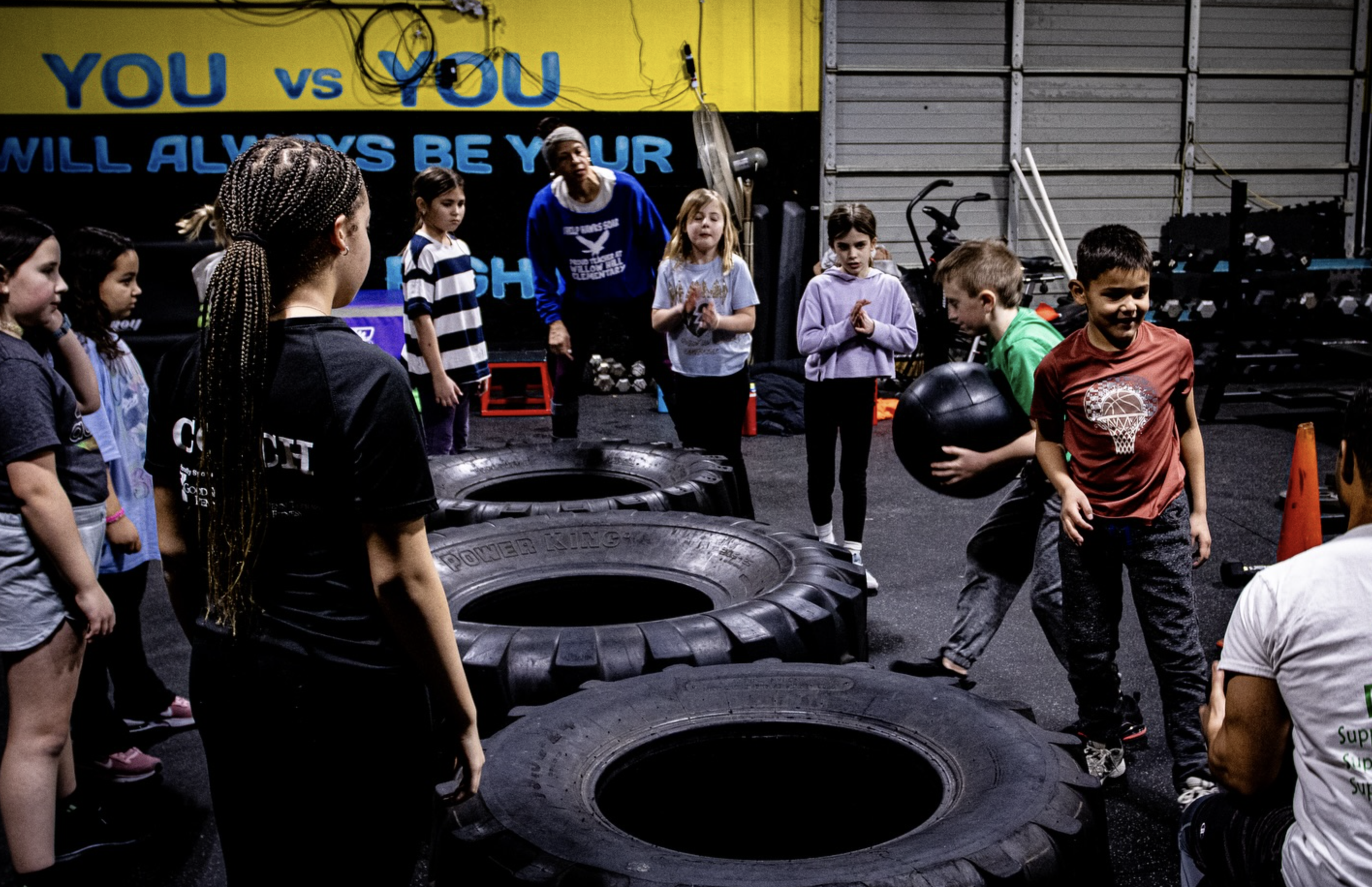 Young athletes hydrating and exercising safely outdoors during summer, showcasing proper clothing, hydration practices, and shaded workout environments