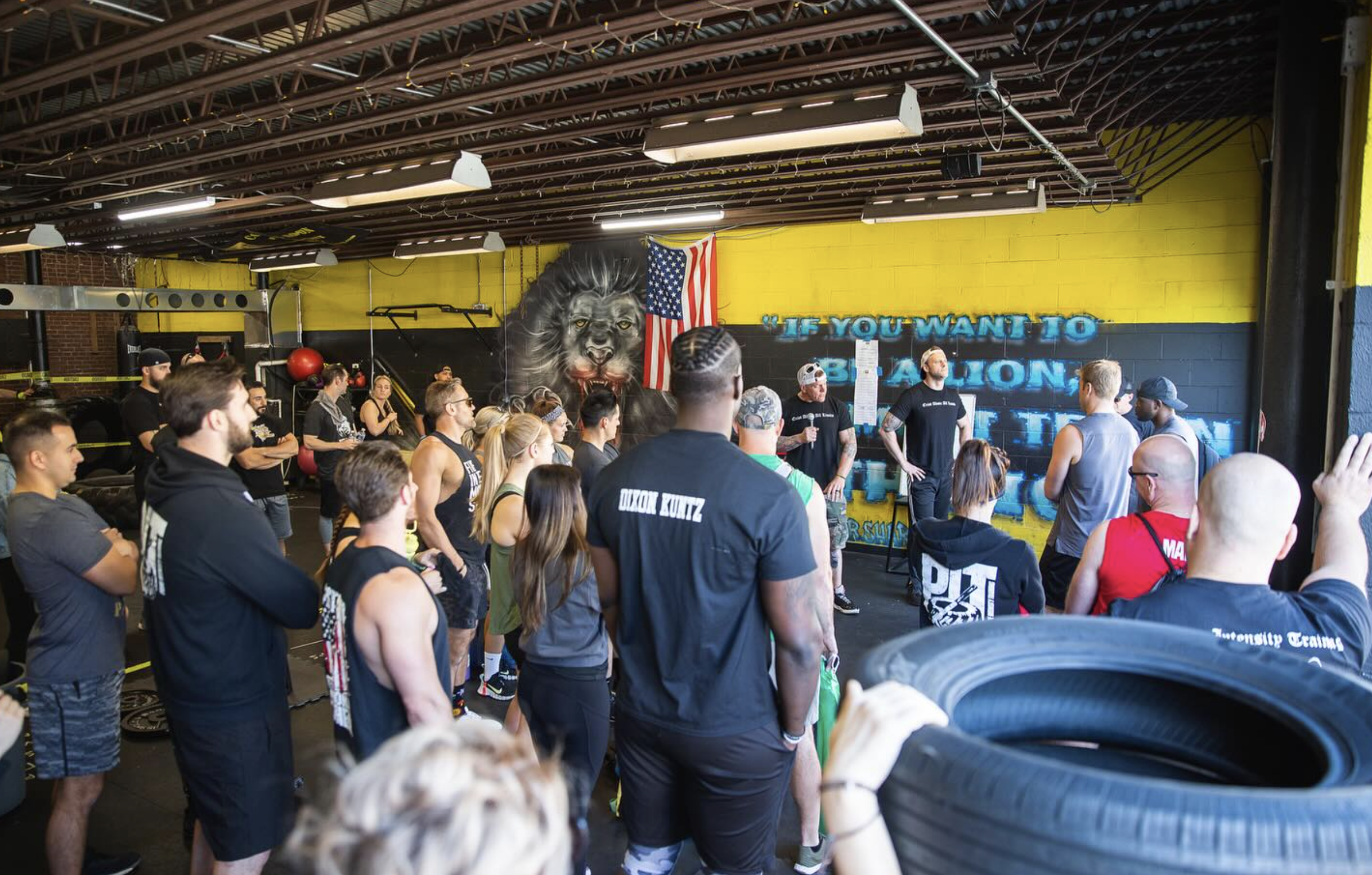 Coach leading a varied HIIT workout session at PIT Conshohocken with members performing different functional movements