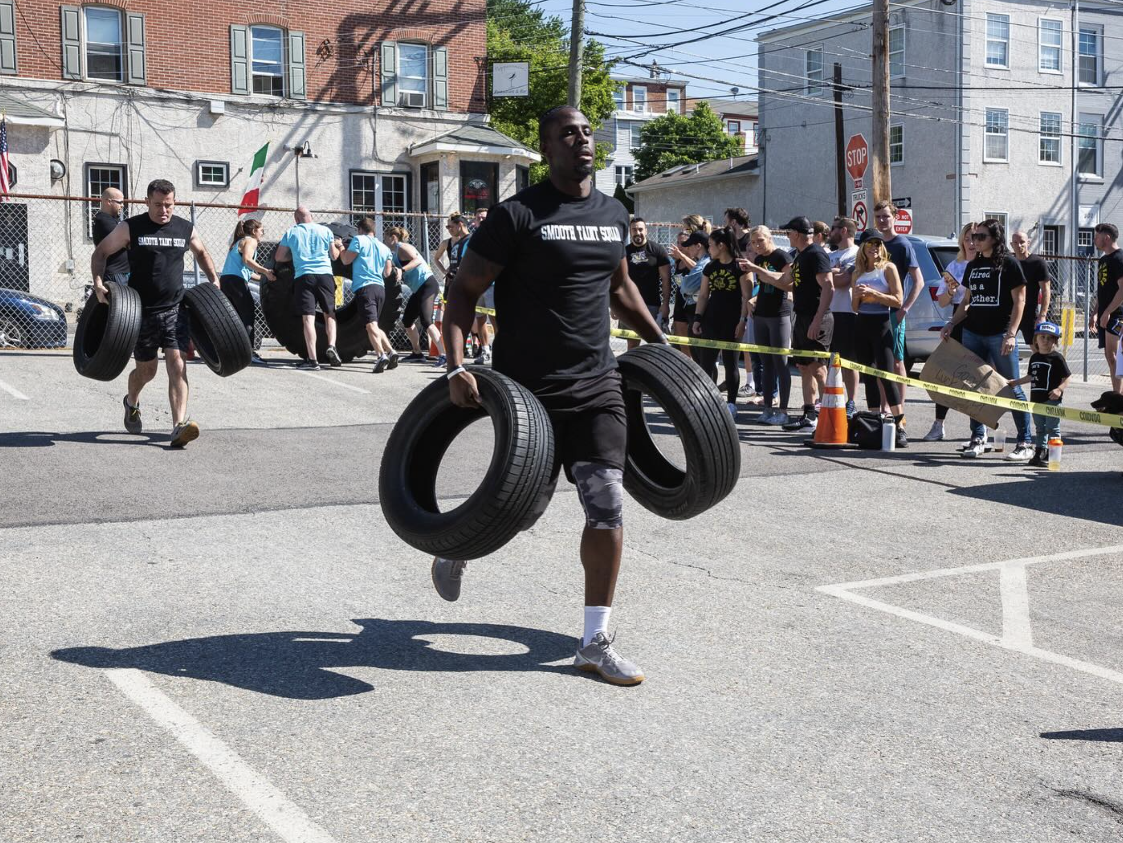 Members carrying tires and rowing intervals during a heart-healthy hybrid training session at PIT Conshohocken